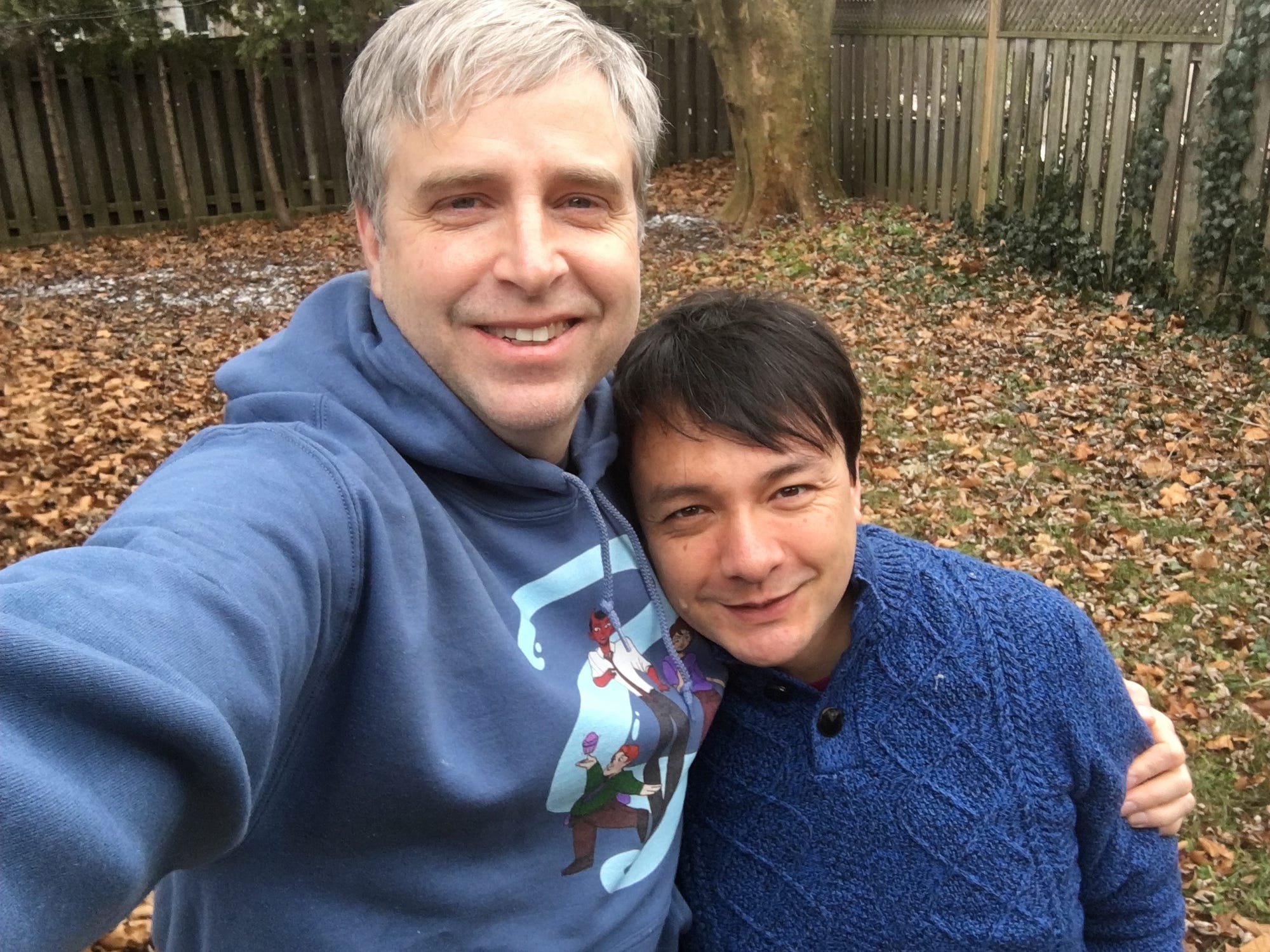 Eli and Sean taking a selfie together. Sean is wearing an other bothers sweatshirt and Eli a blue sweater.