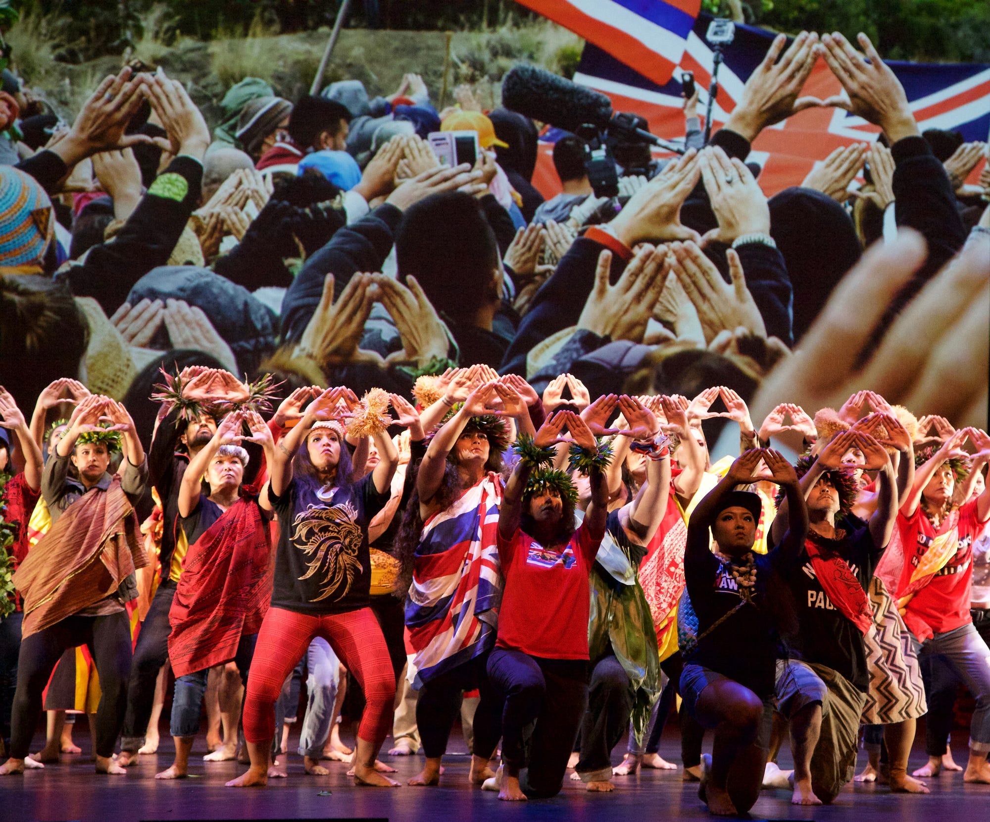 Group of Hawaiian performers making hand gesture forward
