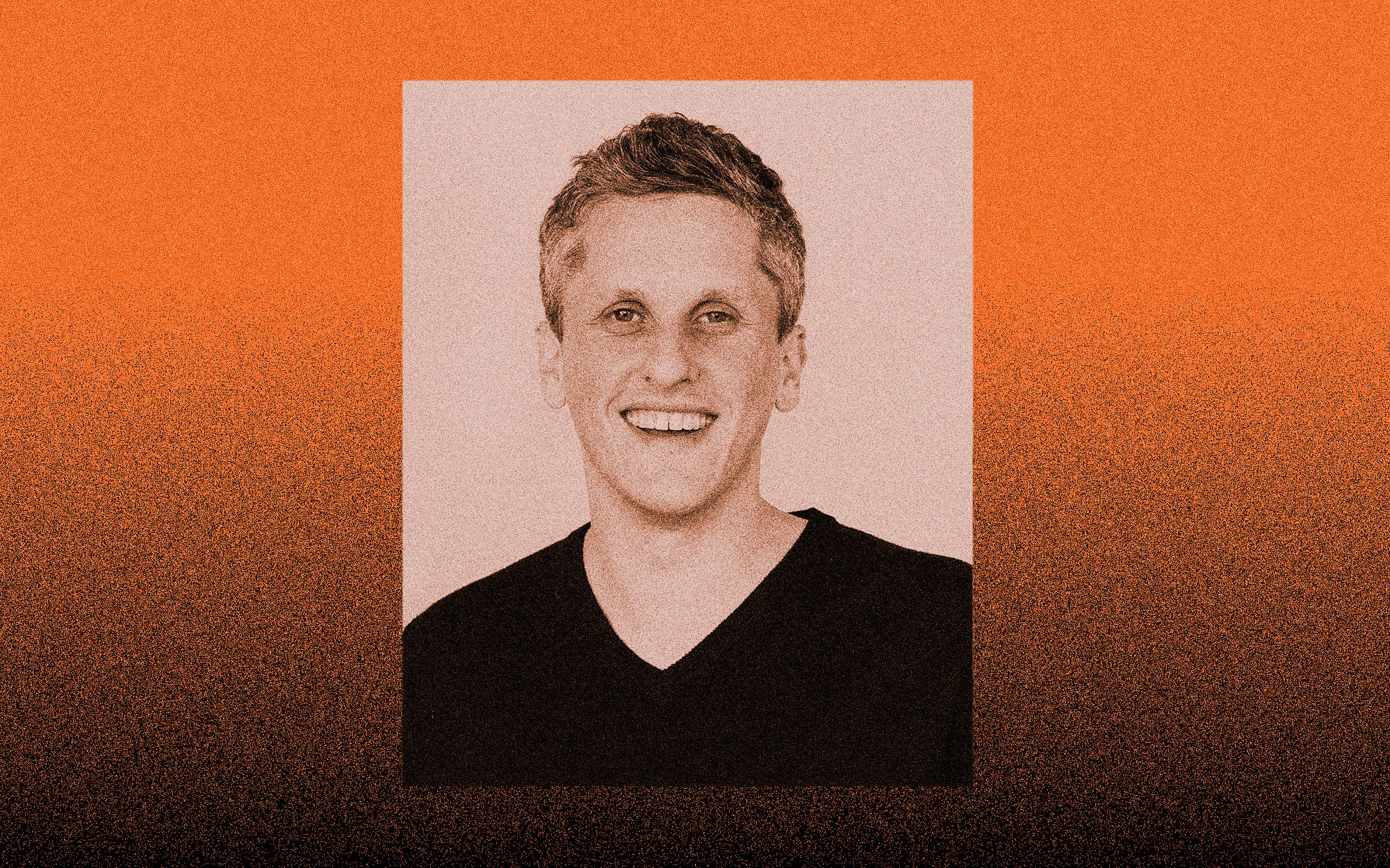 A photo of Aaron Levie against an orange gradient to black background.