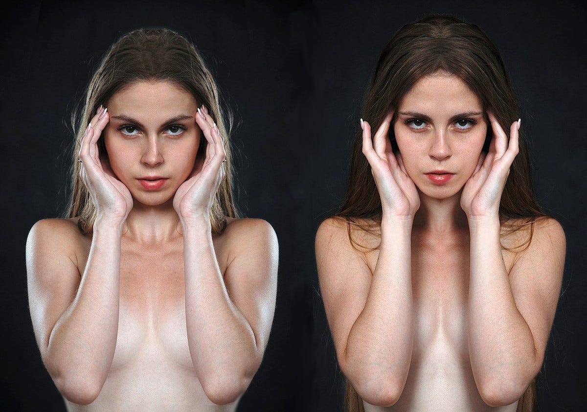 Two similar looking women, seen from the waist up and implied to be naked, holding their open hands up on either side of their faces.