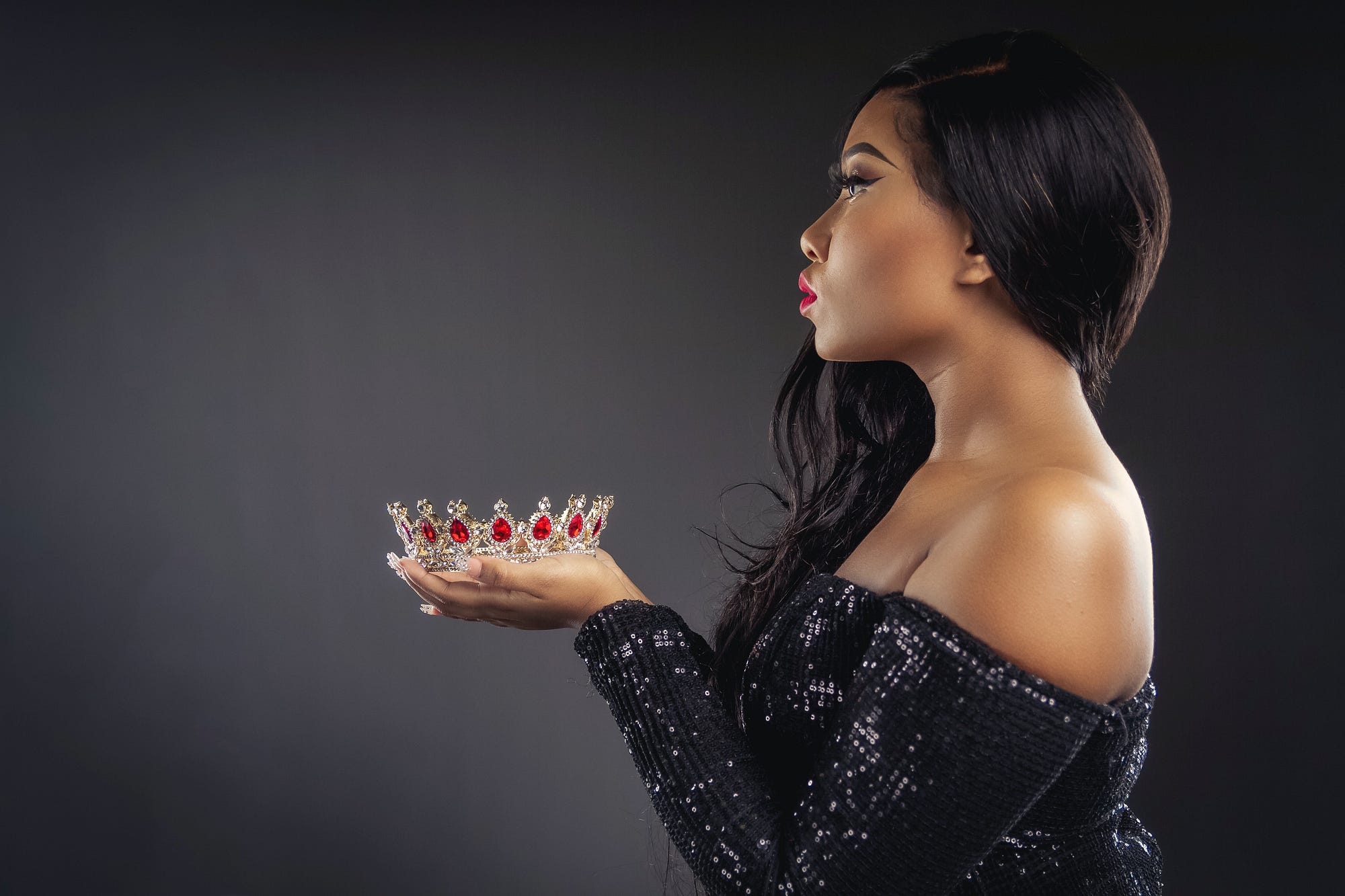 If not you, then who? Black woman holding a crown.