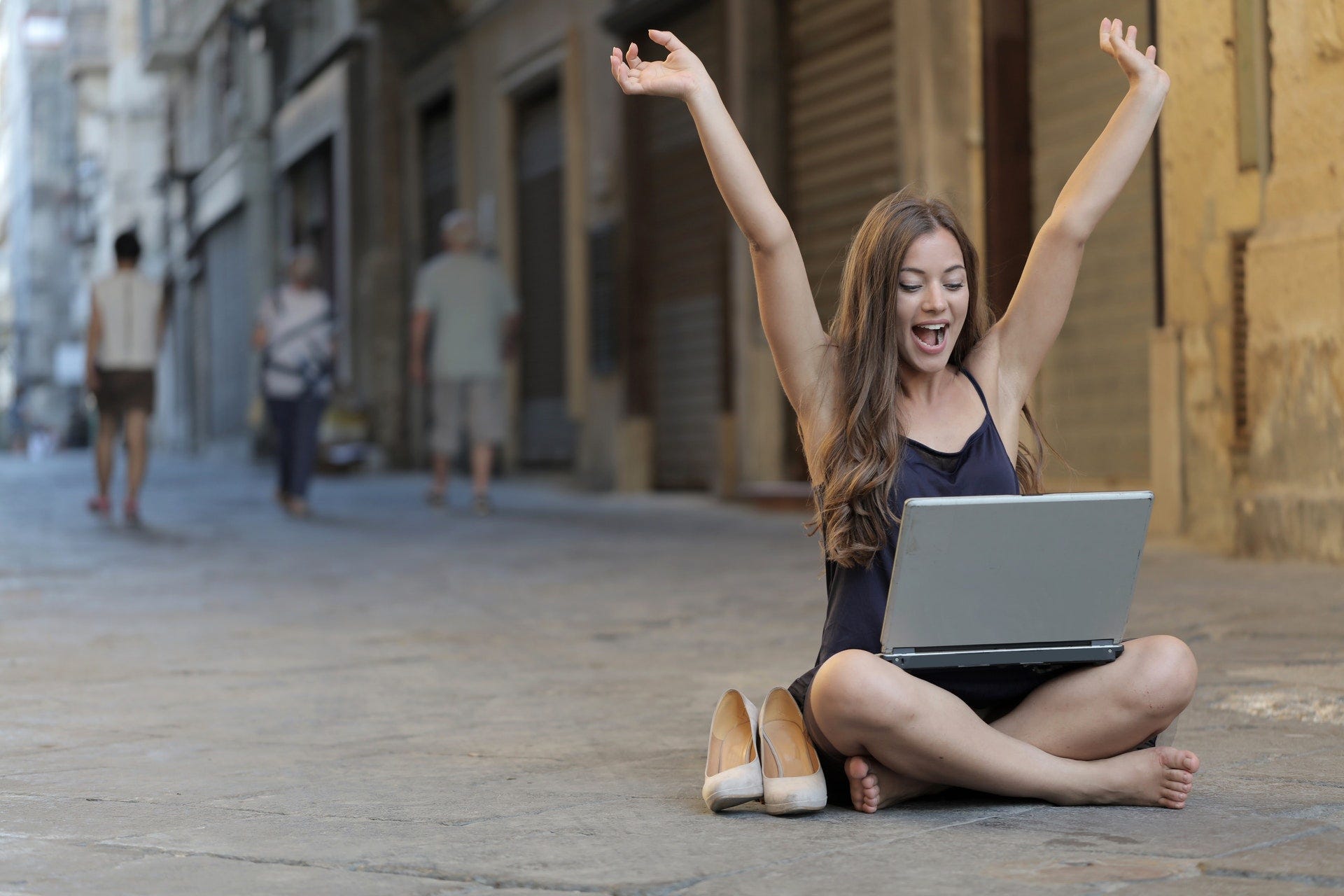 Woman celebrating in front of her laptop