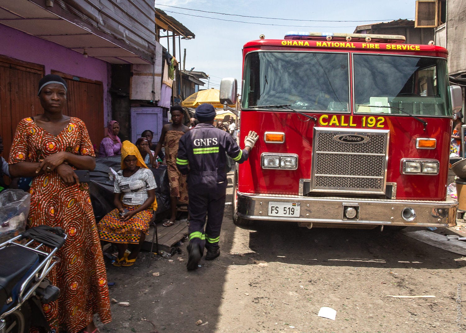 Firefighters reverse from the residence as homes burn to the ground in Agbogbloshie, Accra, Ghana. April 7, 2020. Photo by Ni
