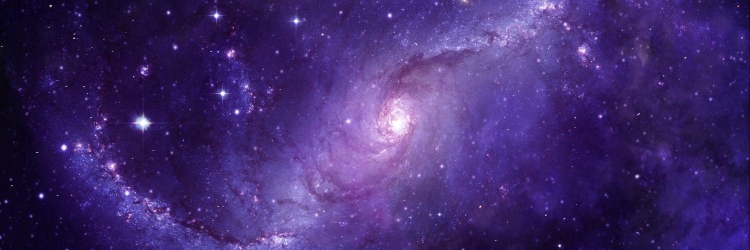 The galaxy swirling colored purple.
