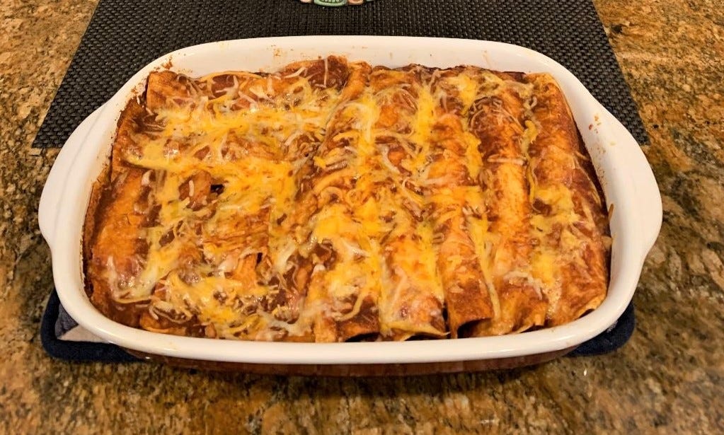 A finished dish of wild turkey enchiladas rests on a counter