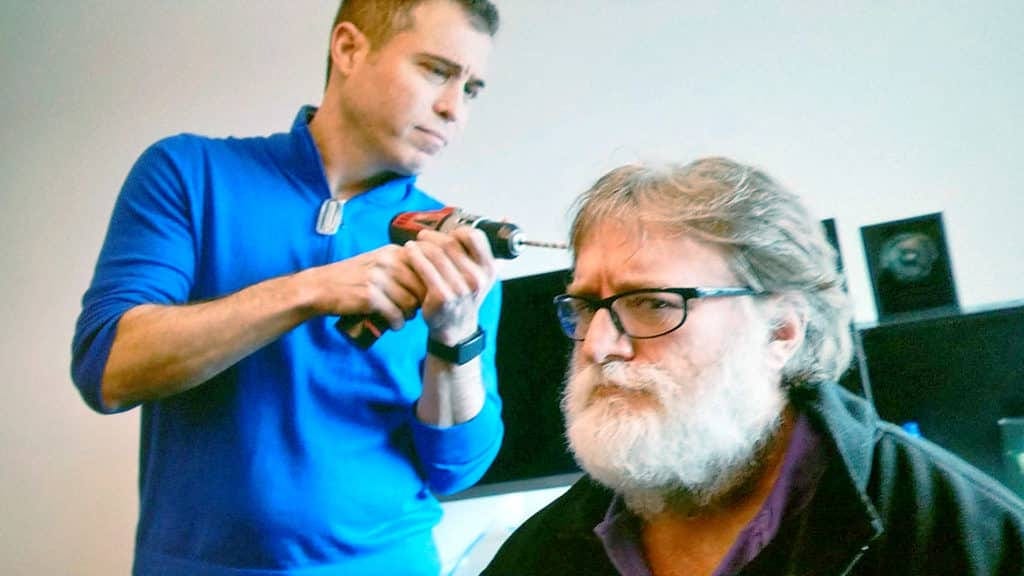 Mike Abinder pretending to drill into Gabe Newell’s brain