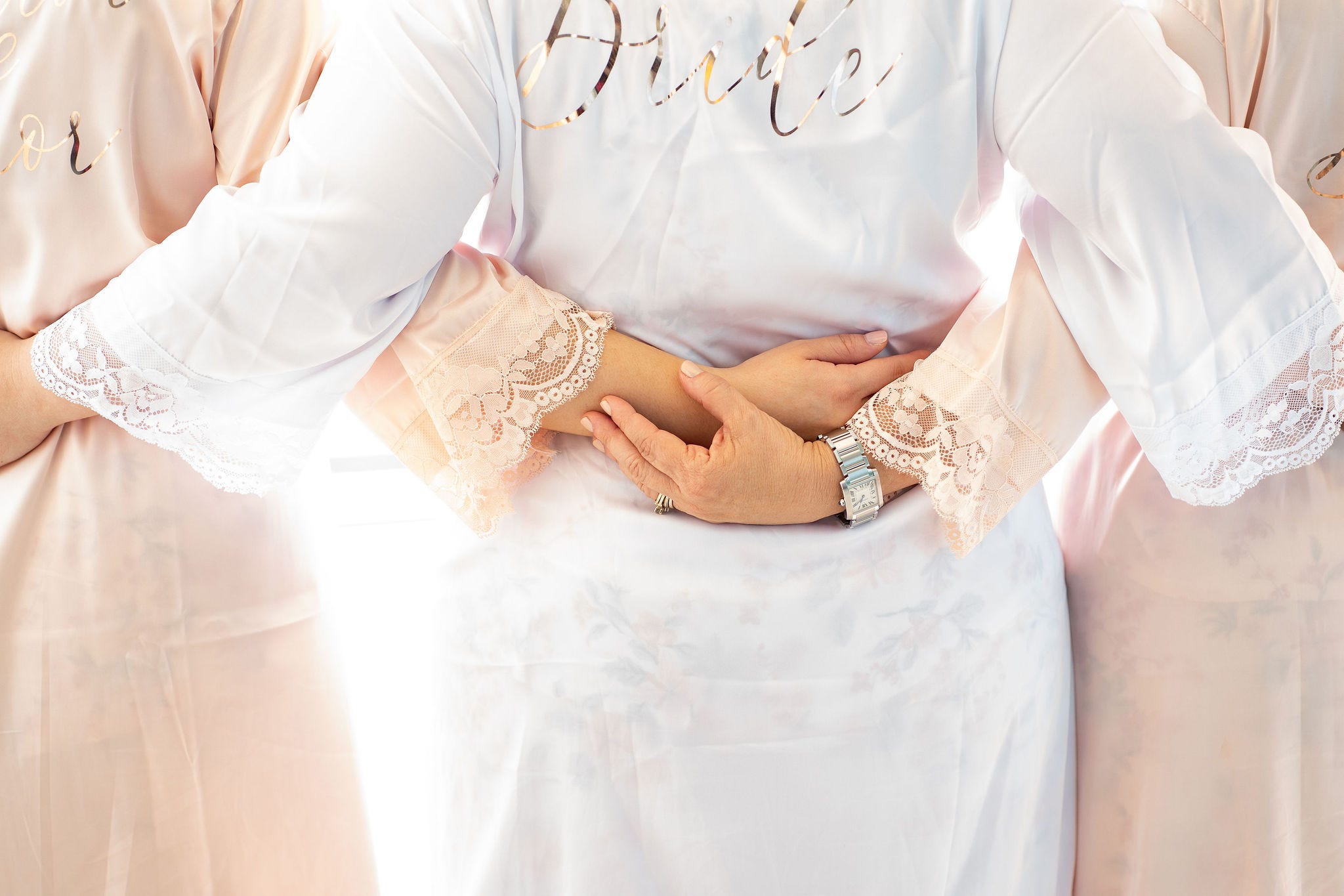 Bride with her bridesmaids in robes.