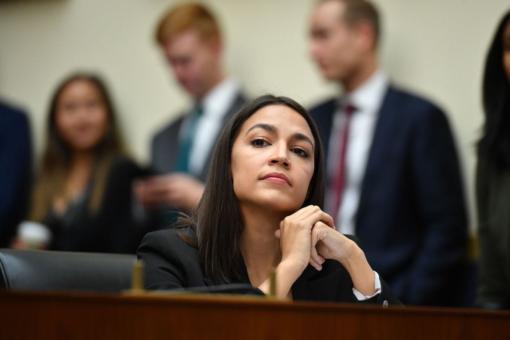Representative Alexandria Ocasio-Cortez listens during a hearing.
