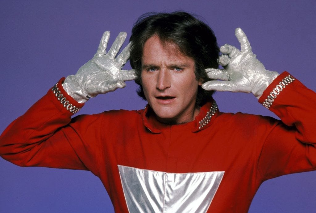 Comedian Robin Williams in his red and silver “Mork” costume