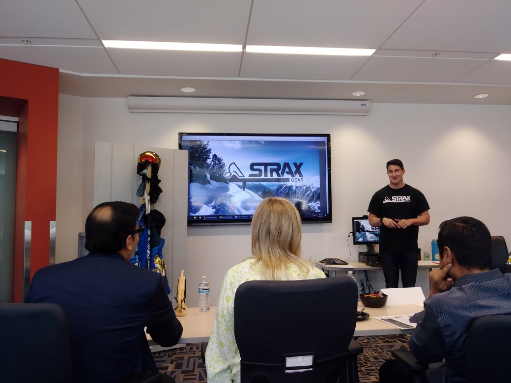 Strax Gear presents their company with a presentation and examples of their products to three judges.