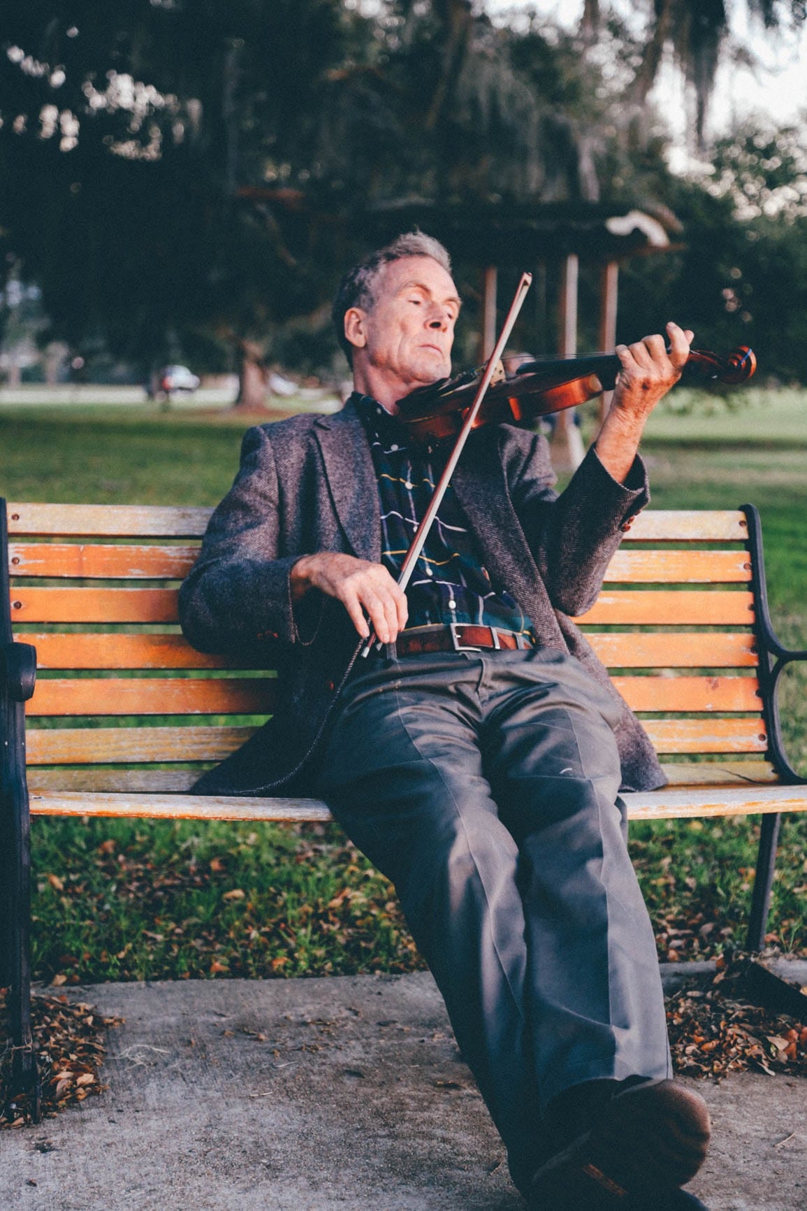 Oldr person playing a violin to the woes of ageist youth