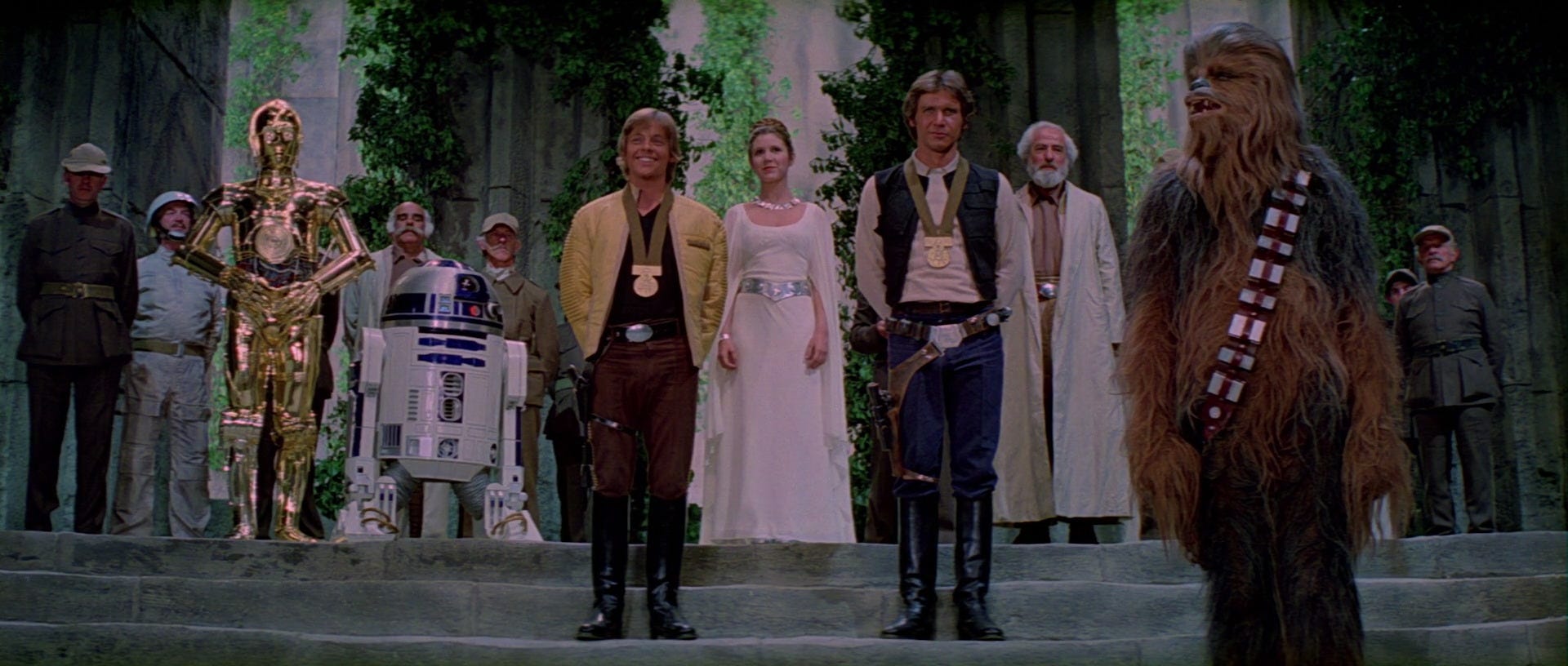 Luke, Han, Leia, Chewie, and the droids at the medal ceremony