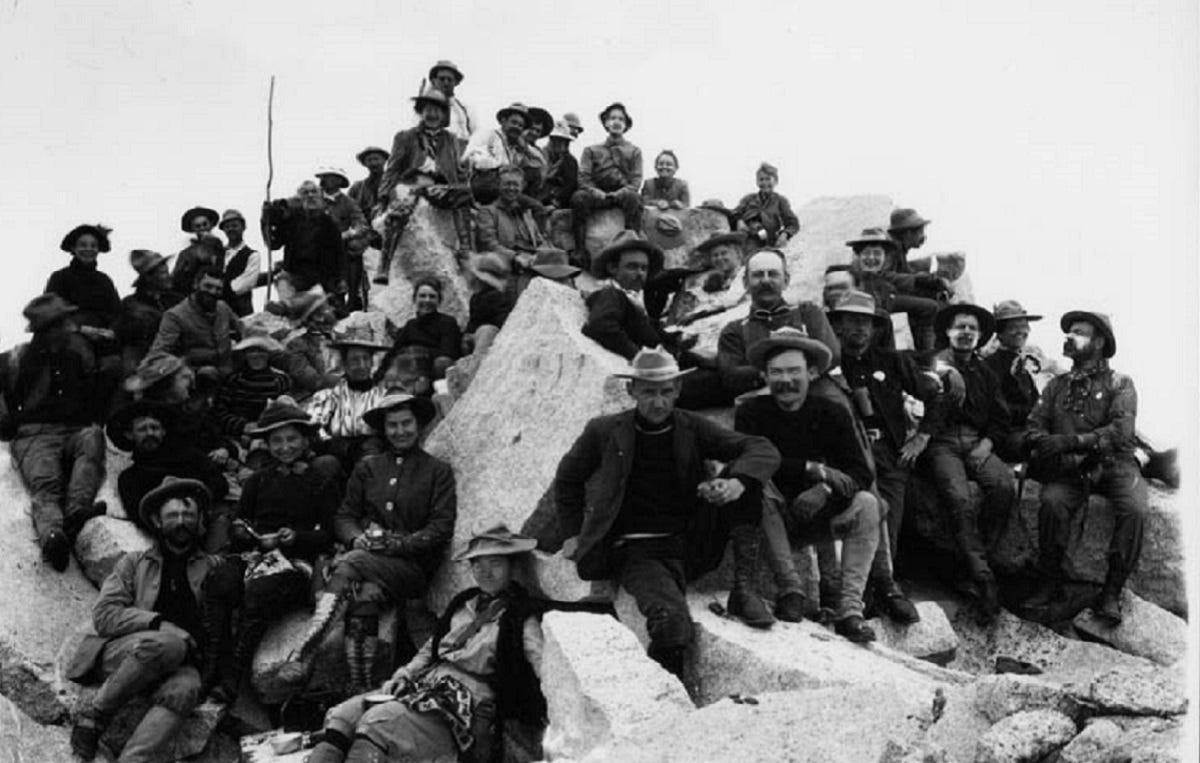 A group of turn-of-the-century Sierra Club members on the rocky top of Mt. Brewer.
