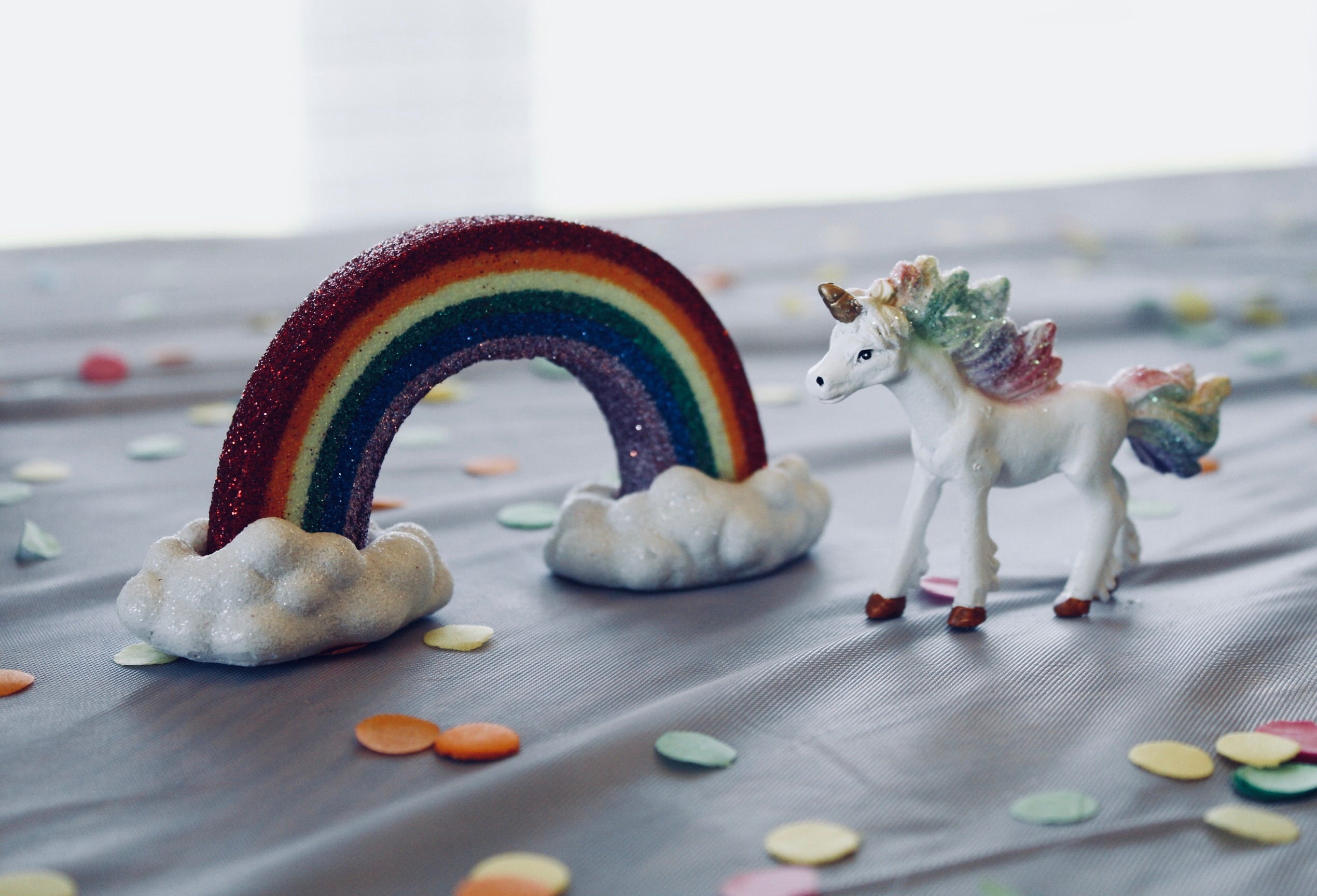 rainbow figurine and unicorn figurine