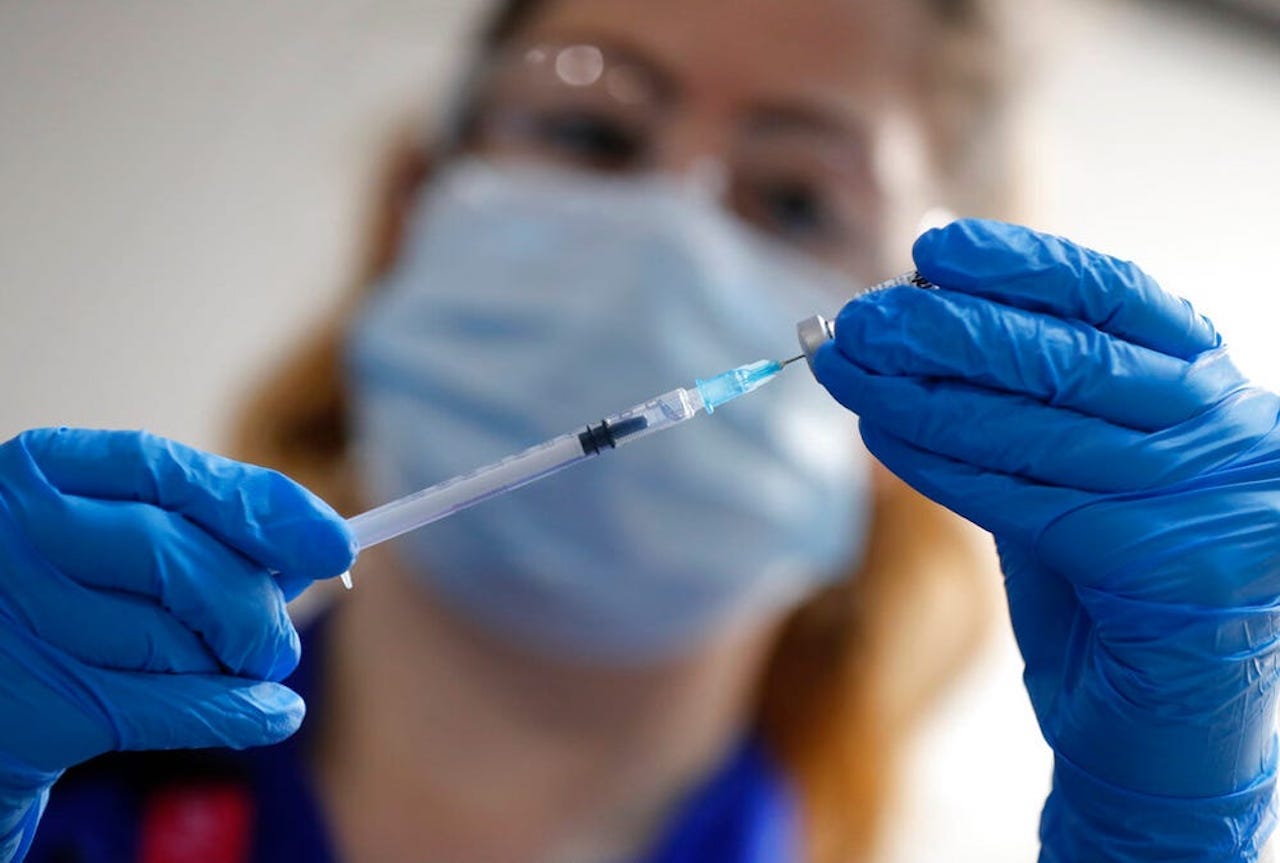 A nurse prepares the Pfizer-BioNTech COVID-19 vaccine in London in December 2020.