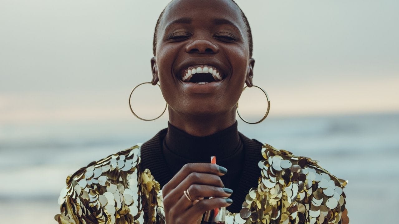 A woman is smiling like she just achieved happiness for the first time.