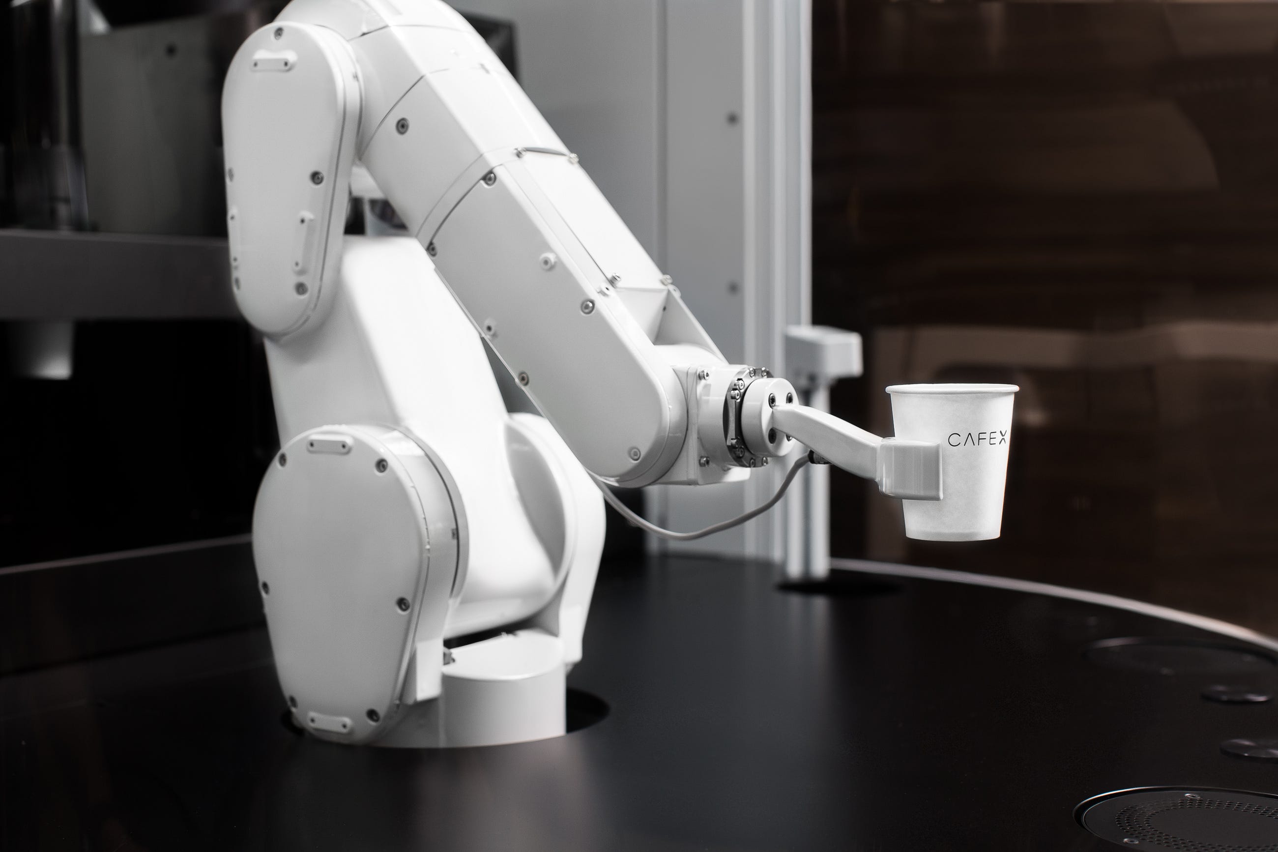 Robot arm holding a cup of coffee