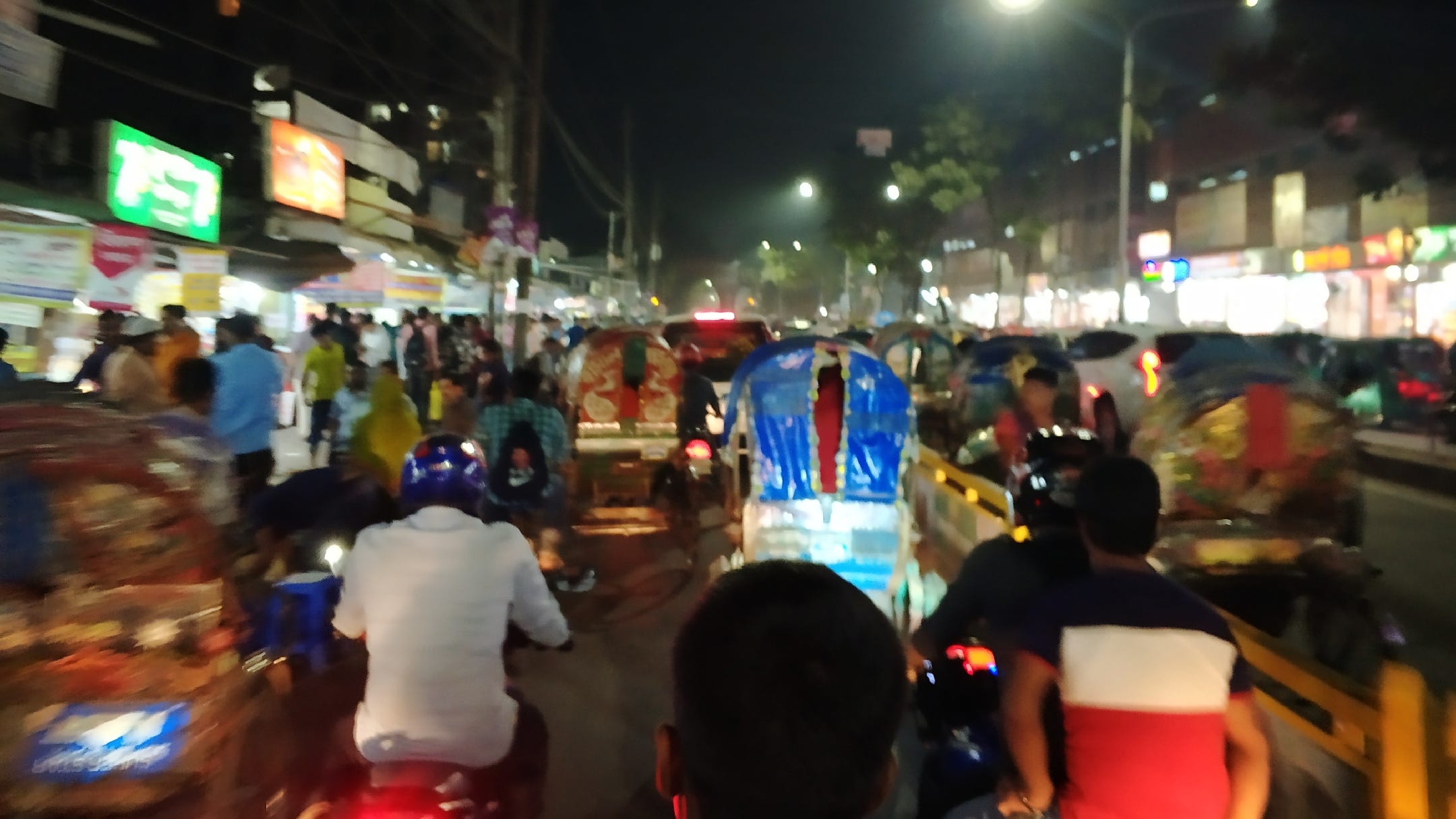 Traffic on tuk tuks and motorbikes in Dhaka