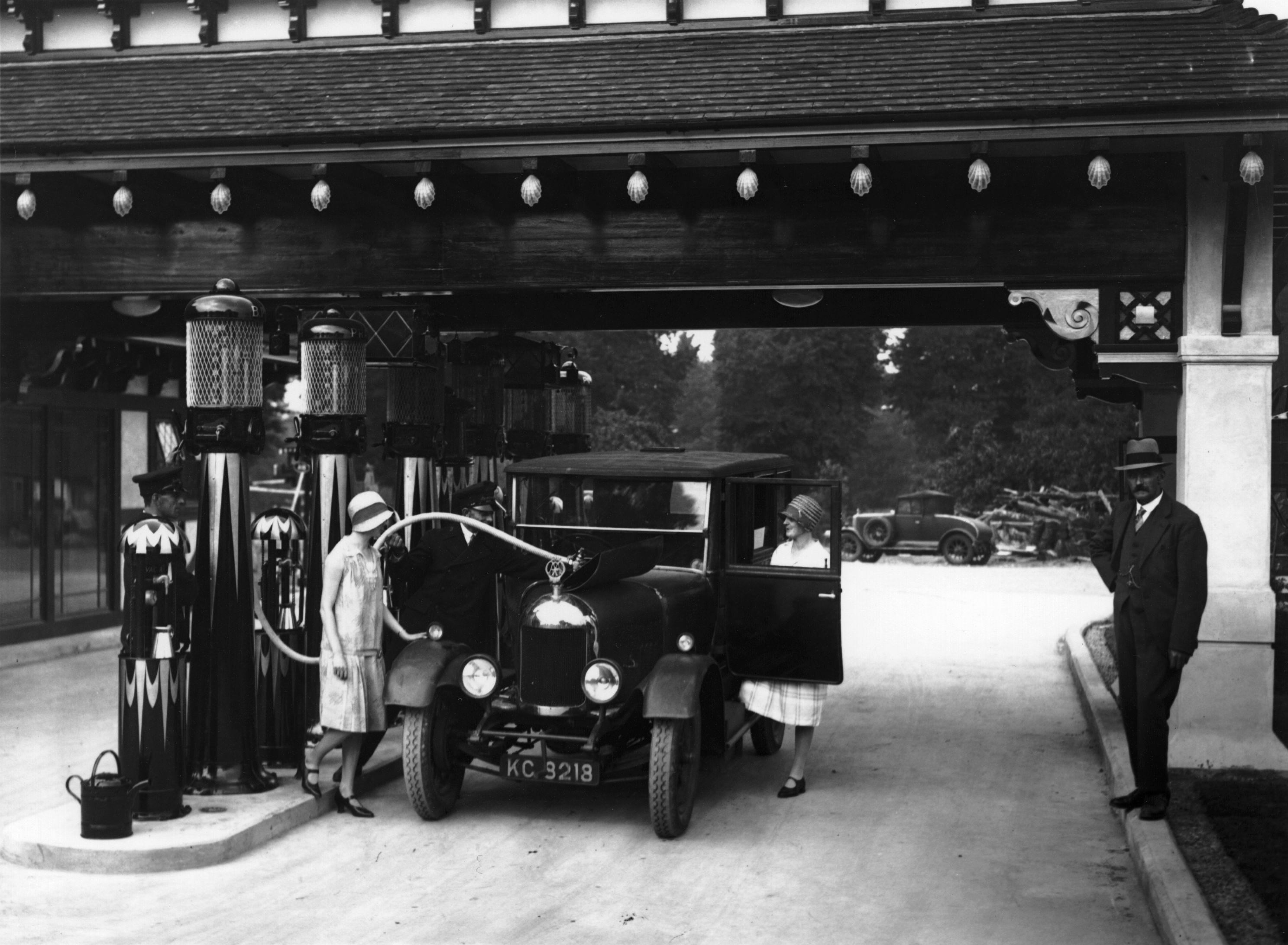 A woman's car being filled up at a petrol station in 1929.