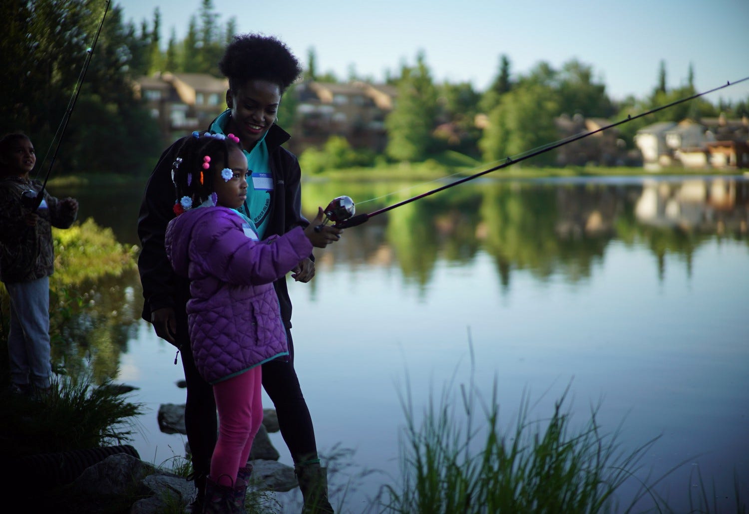 Mom and daughter fishing a lake