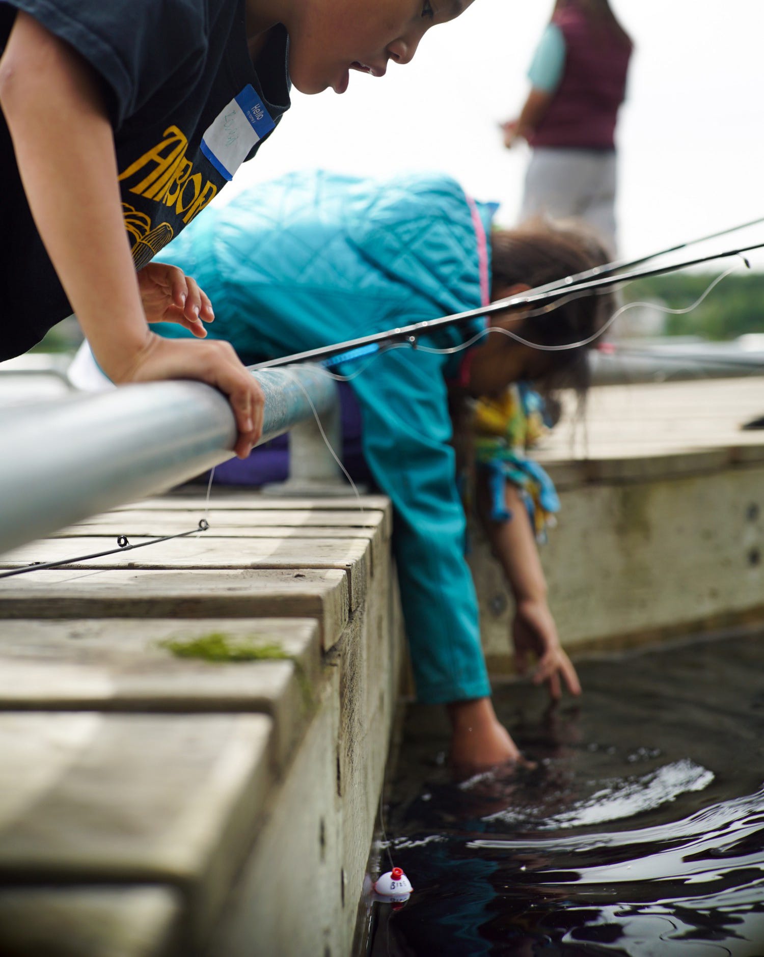 kids bobber fishing off a dock