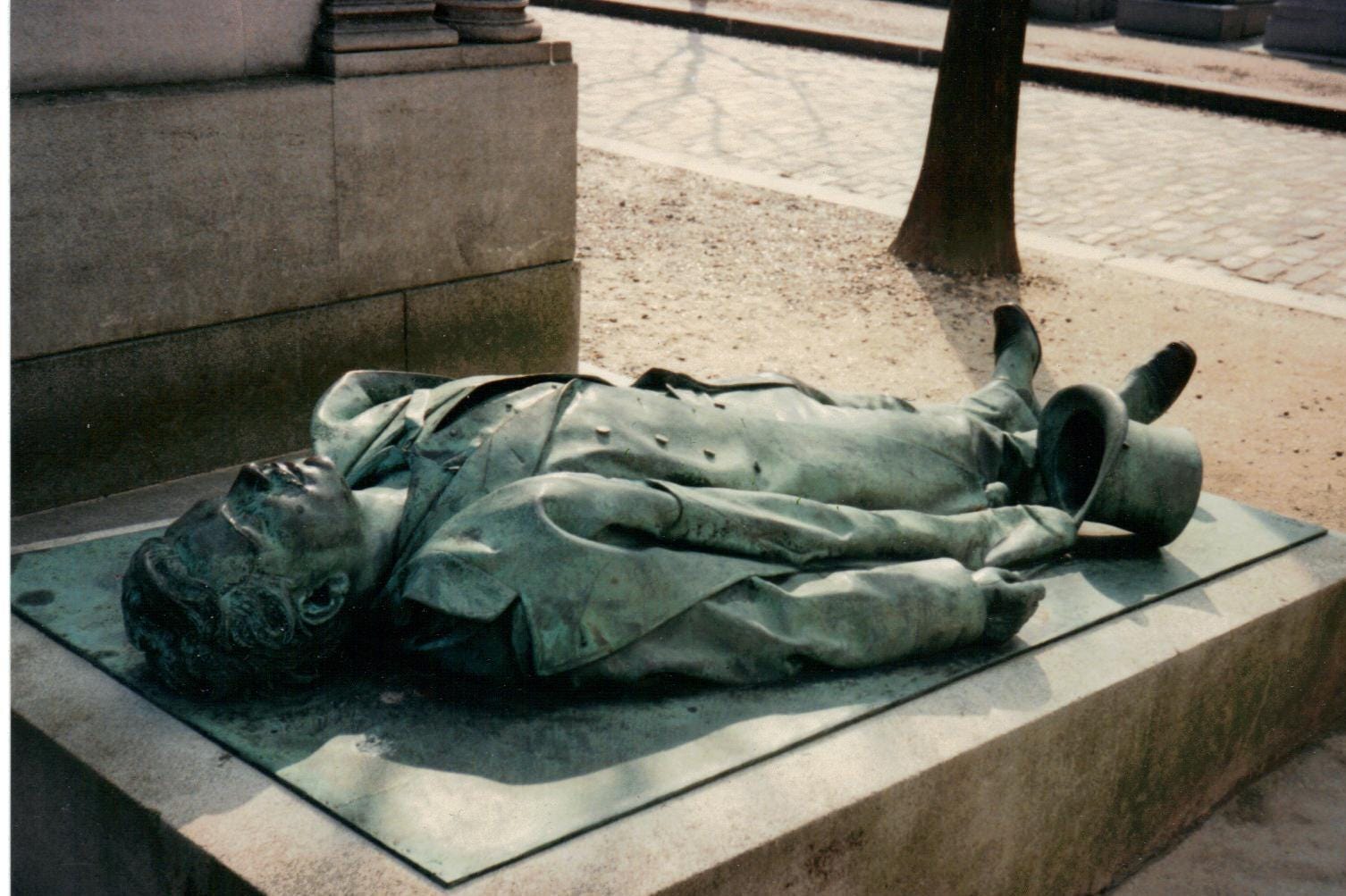 Victor Noir’s tombstone depicts him as he was shot dead.