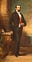 Louis Napoleon Bonaparte painted wearing a black suit and red sash. He has dark hair and a horizontal mustache.
