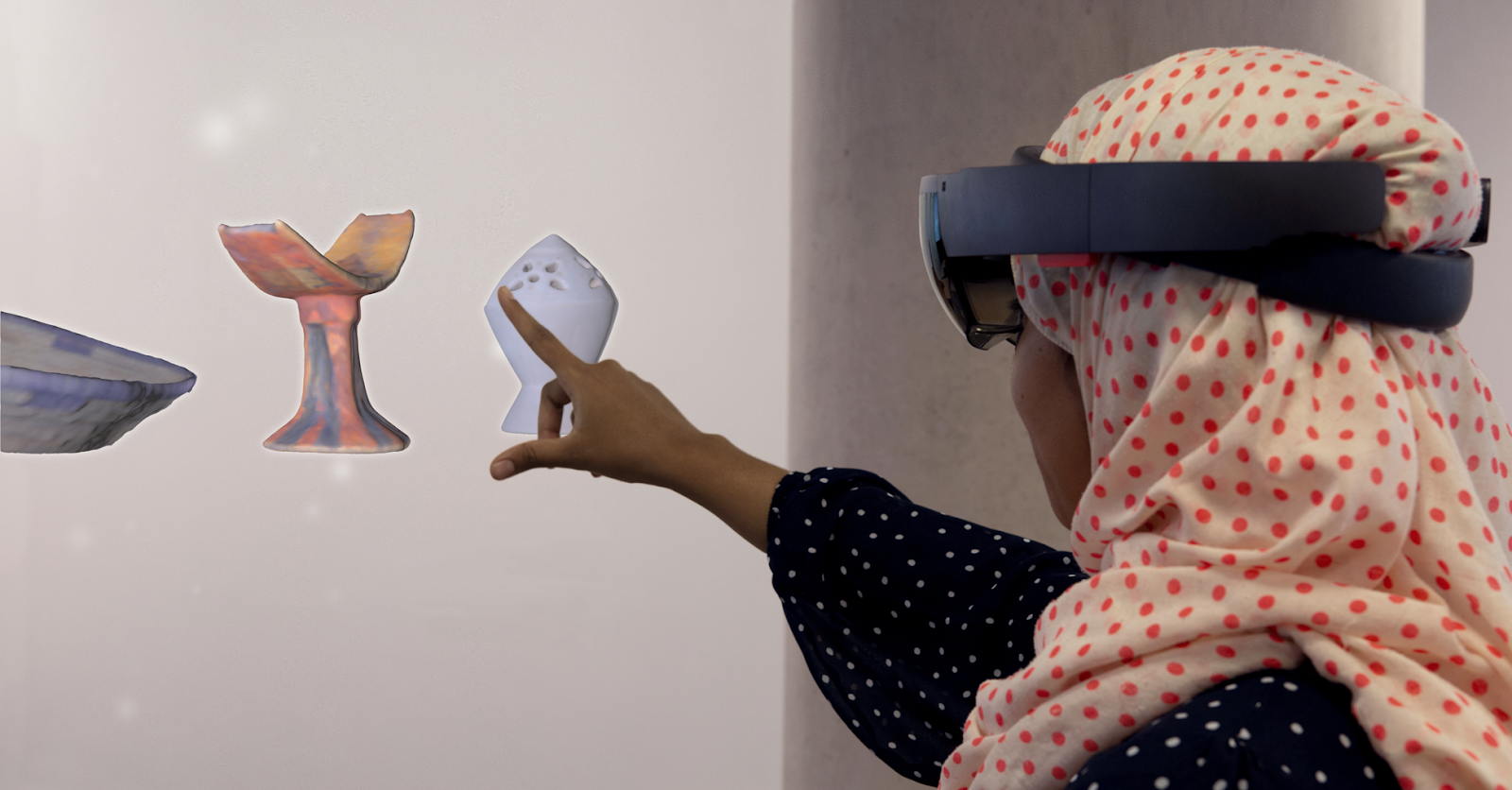 Photo of a person wearing an AR headset interactive with holographic objects