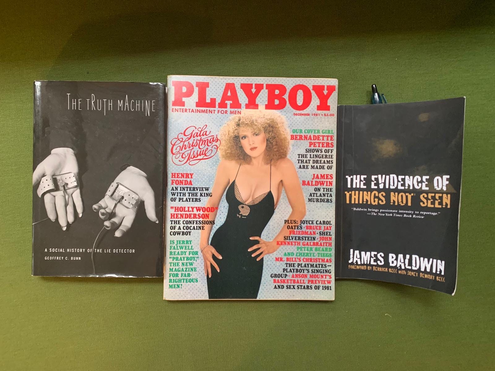 Covers of two books and a Playboy Magazine.