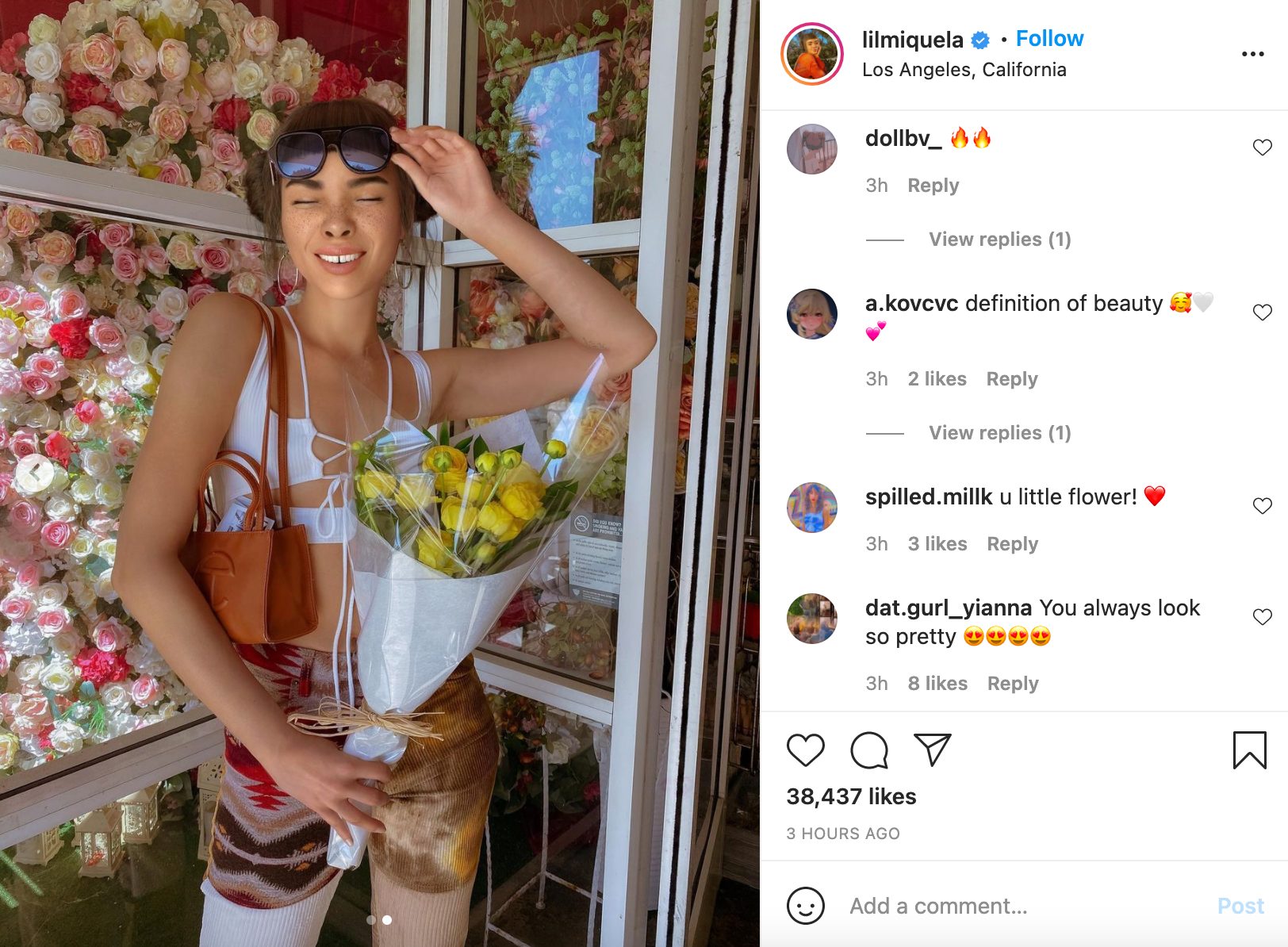 screenshot of @lilmiquela’s instagram account, showing her posing in front of a flower shop, with comments from fans including “u little flower! :heart-emoji:”