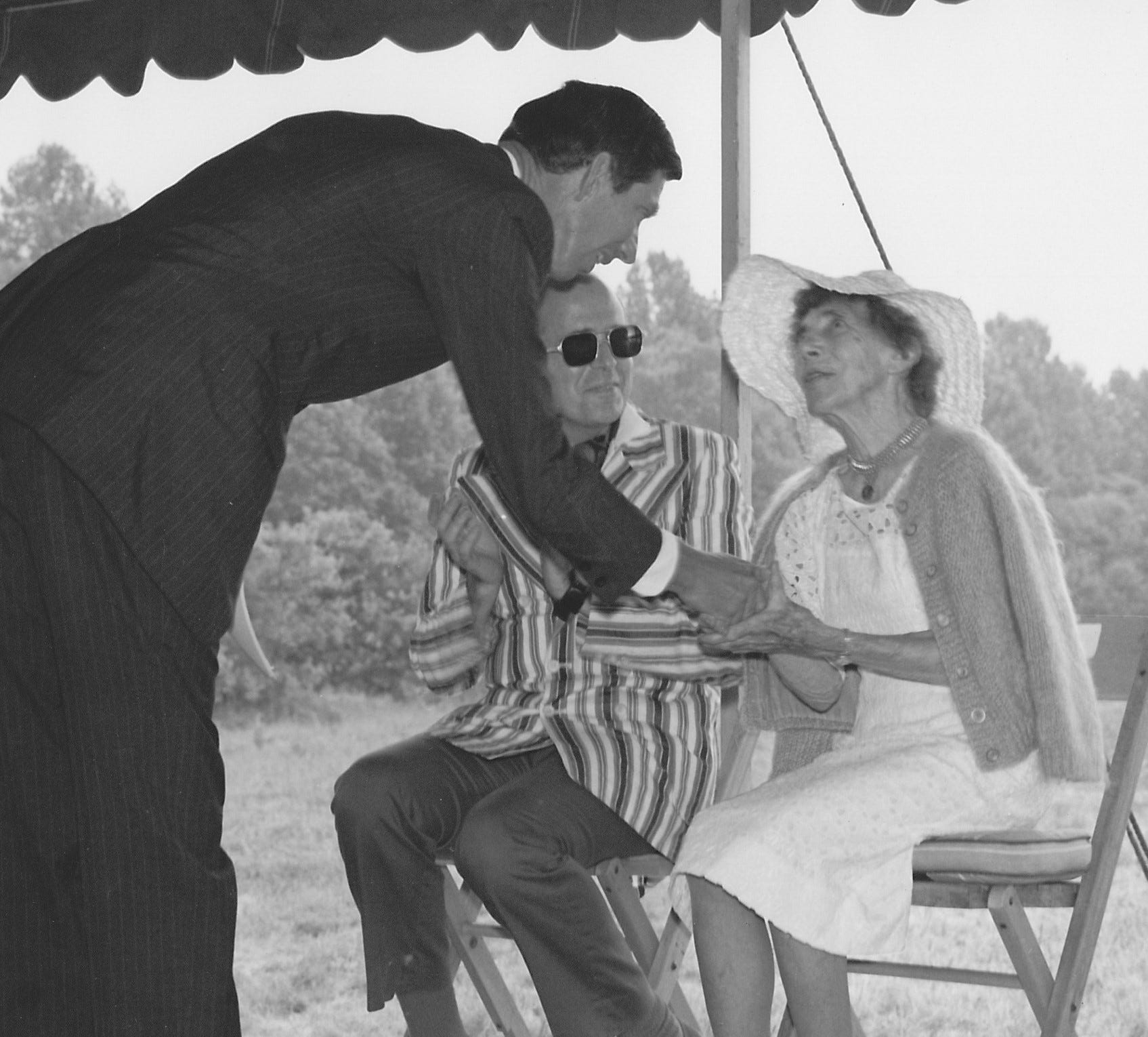 a man shakes a woman’s hand