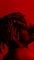 Beautiful black man covering his face in red lighting