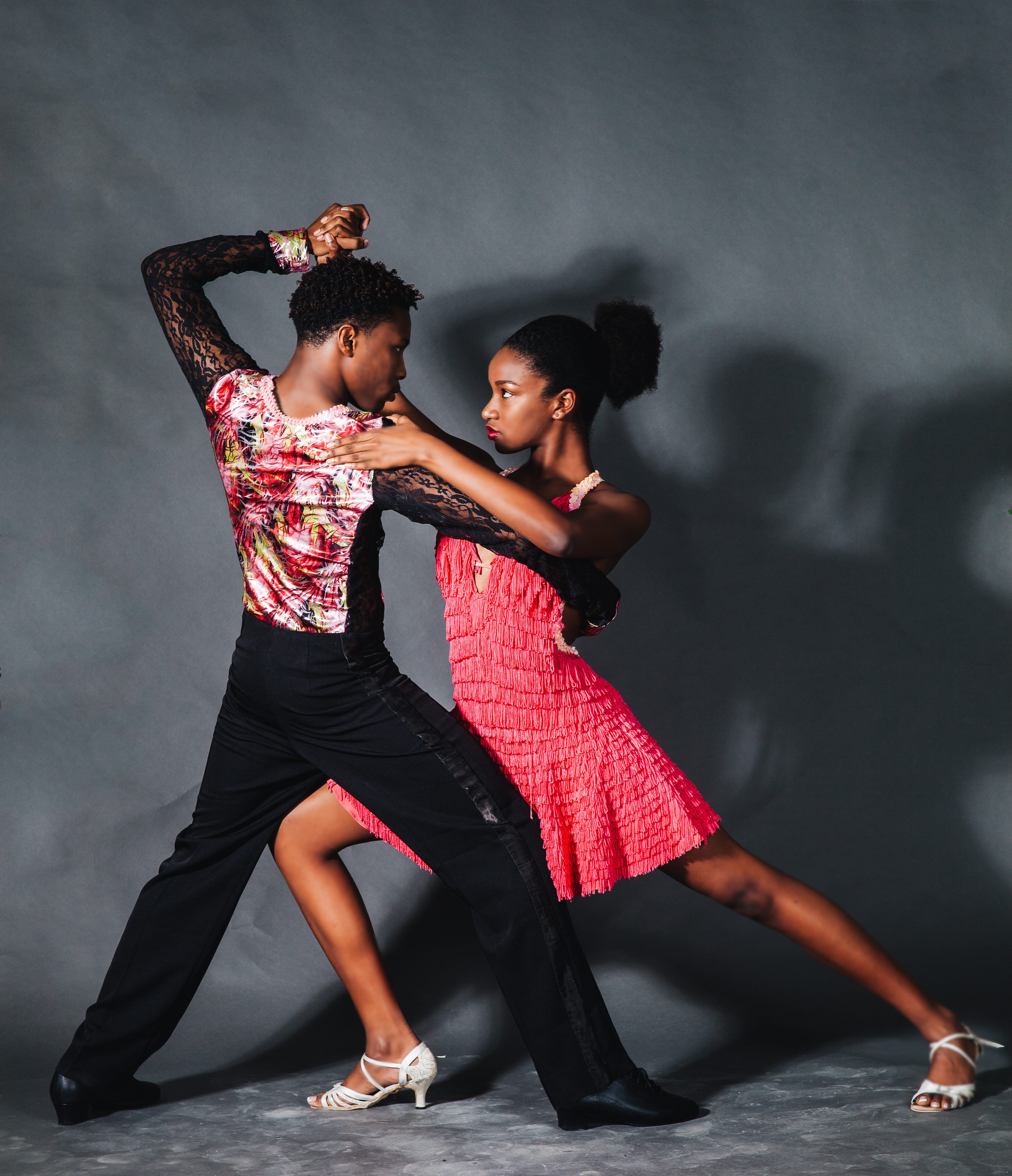 A couple in the middle of a ballroom dance