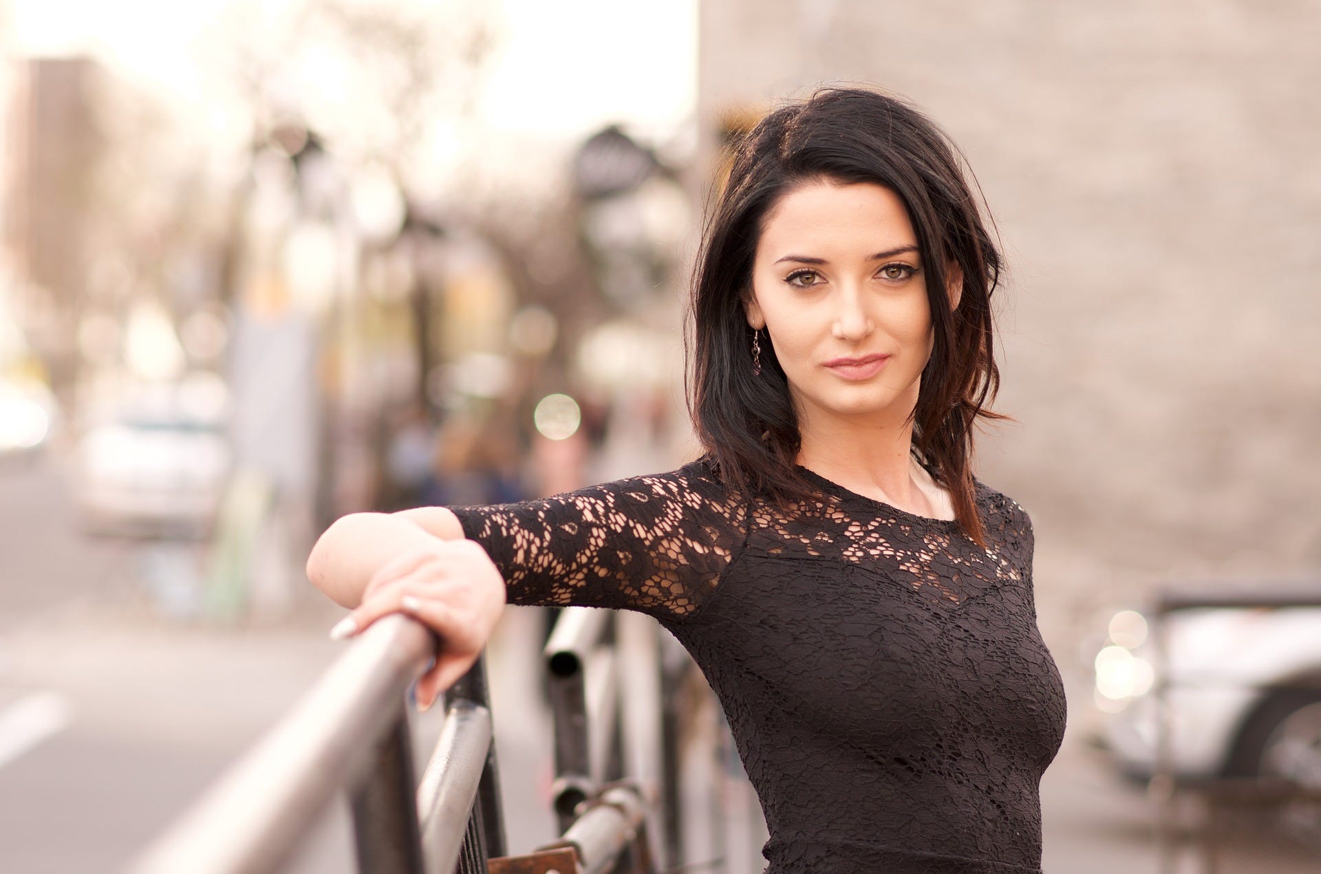 Woman staring at the camera on a busy street. Knowing Your ‘Why’ Will Make You a Better Writer