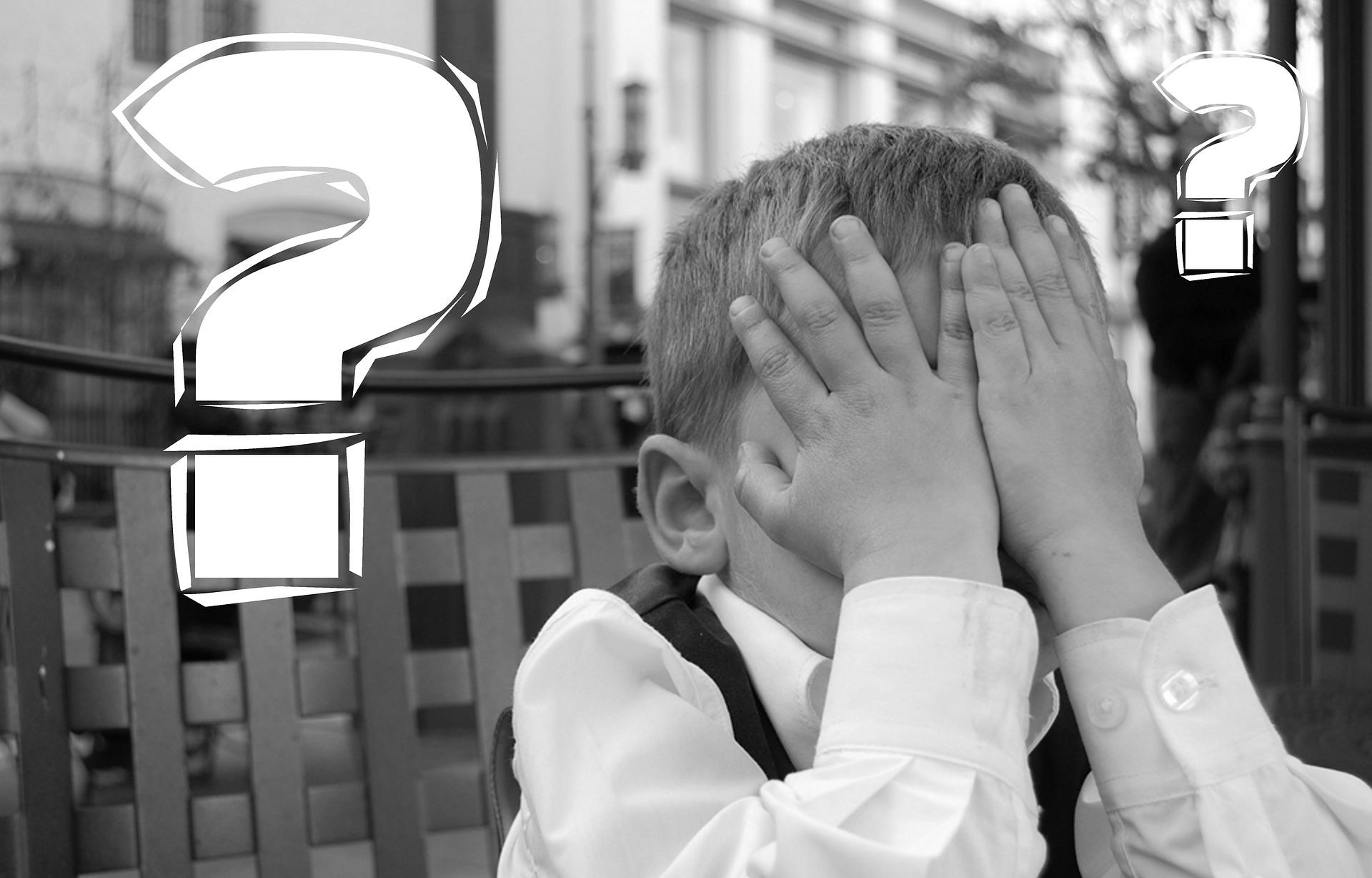question marks, and kid holding his hands over his face as though he made a mistake