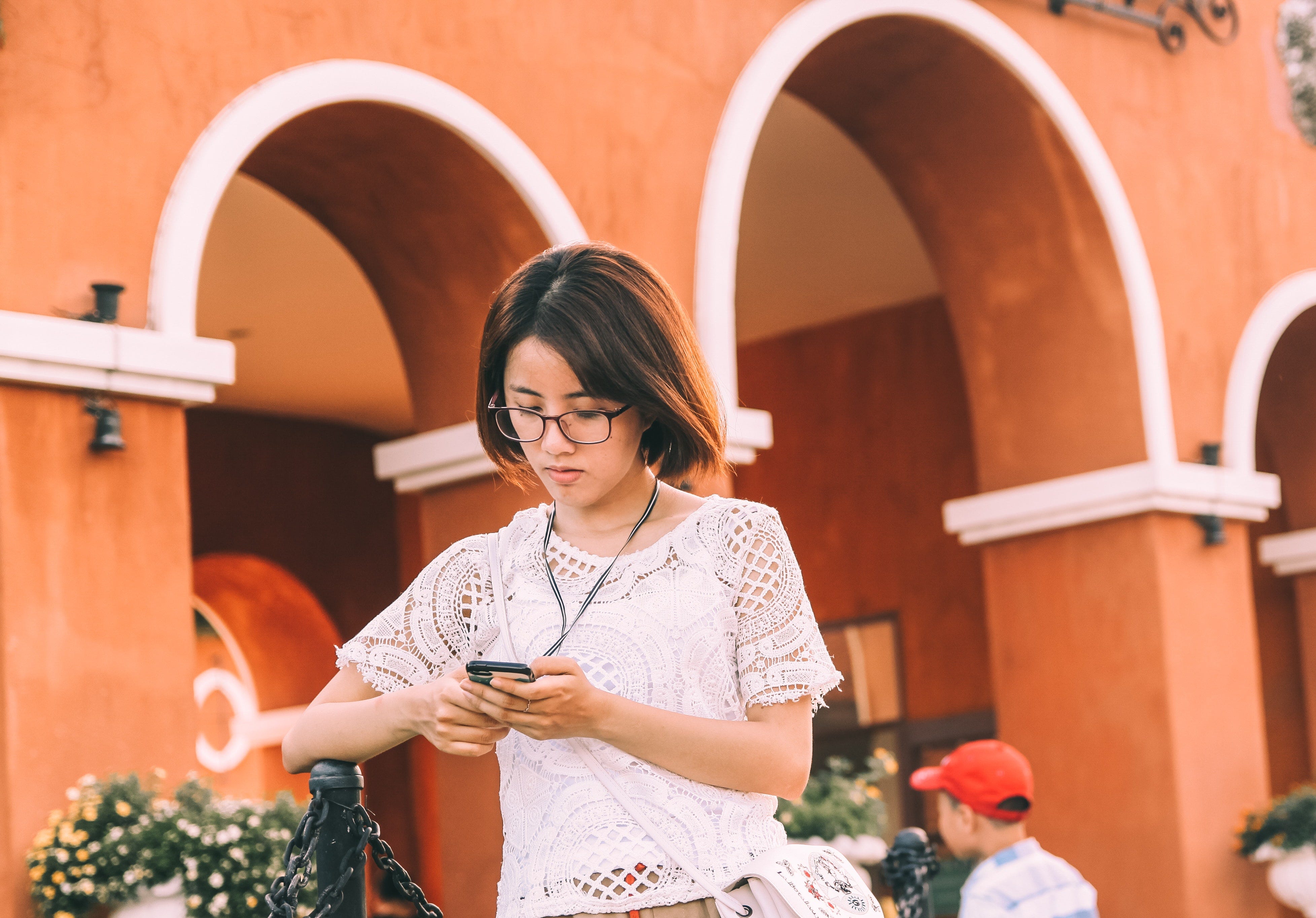 A woman sends a message on her phone