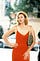 Still of Kim Cattrall as Samantha Jones in a red dress and sexy, confident pose from Sex and the City’s fourth season