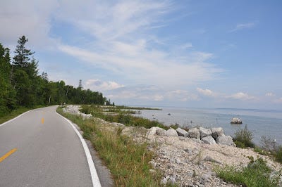 Mackinac Island bike trail with Lake Huron in the distance.