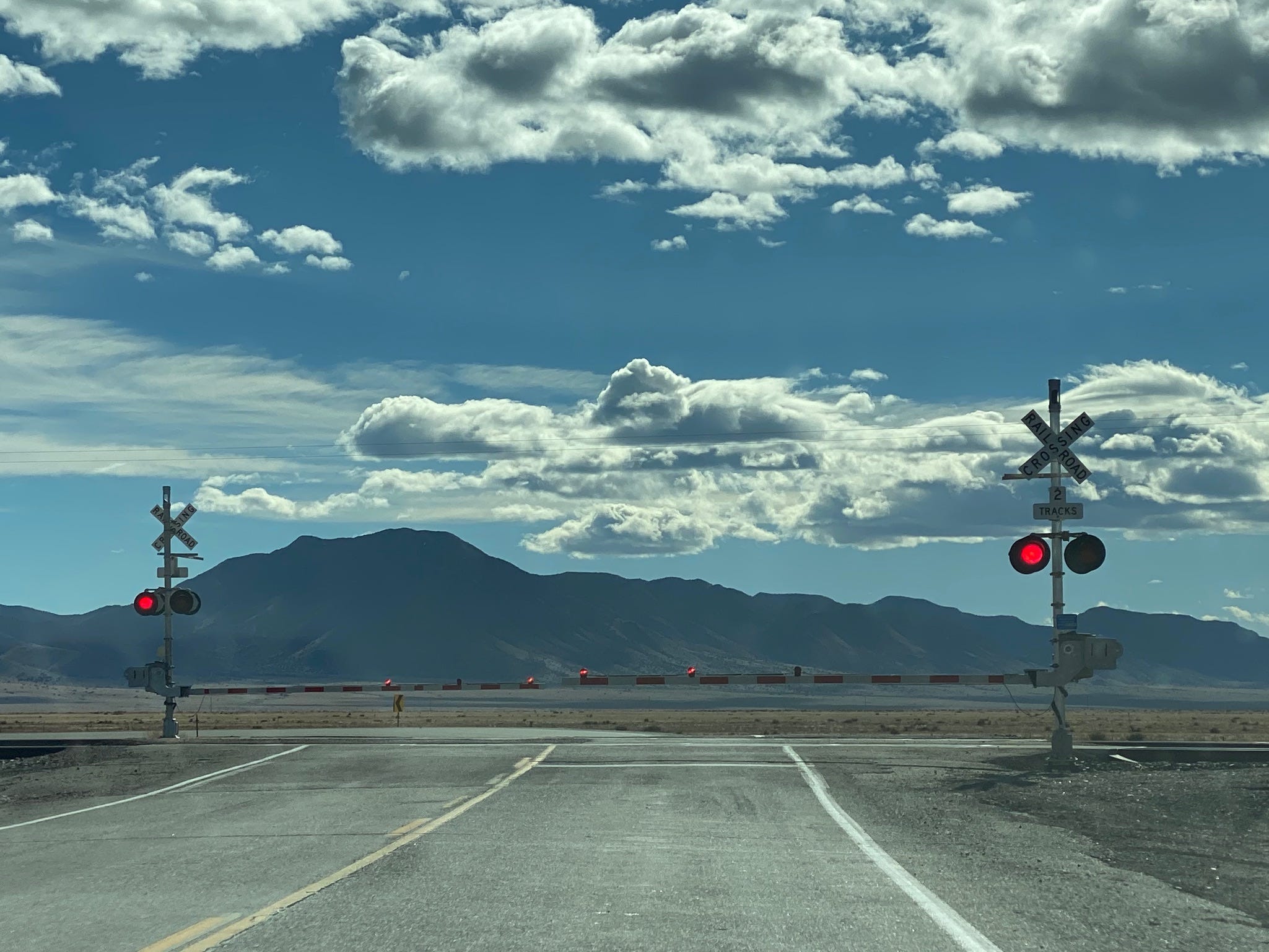 The view toward the south of a railroad crossing where NM 47 intersects with US 60 south of Belen, New Mexico