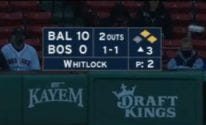 Image of NESN’s baseball score bug. The Baltimore Orioles lead the Boston Red Sox, 10 to 0. Garrett Whitlock has thrown two pitches. It is the top of the 3rd inning with 2 outs, 1 ball and 1 strike.