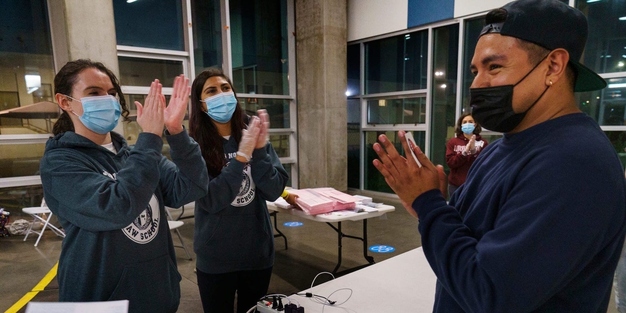Loyola Law School students congratulate Hector Escobar Solis, a first-time voter, in Los Angeles on Tuesday.