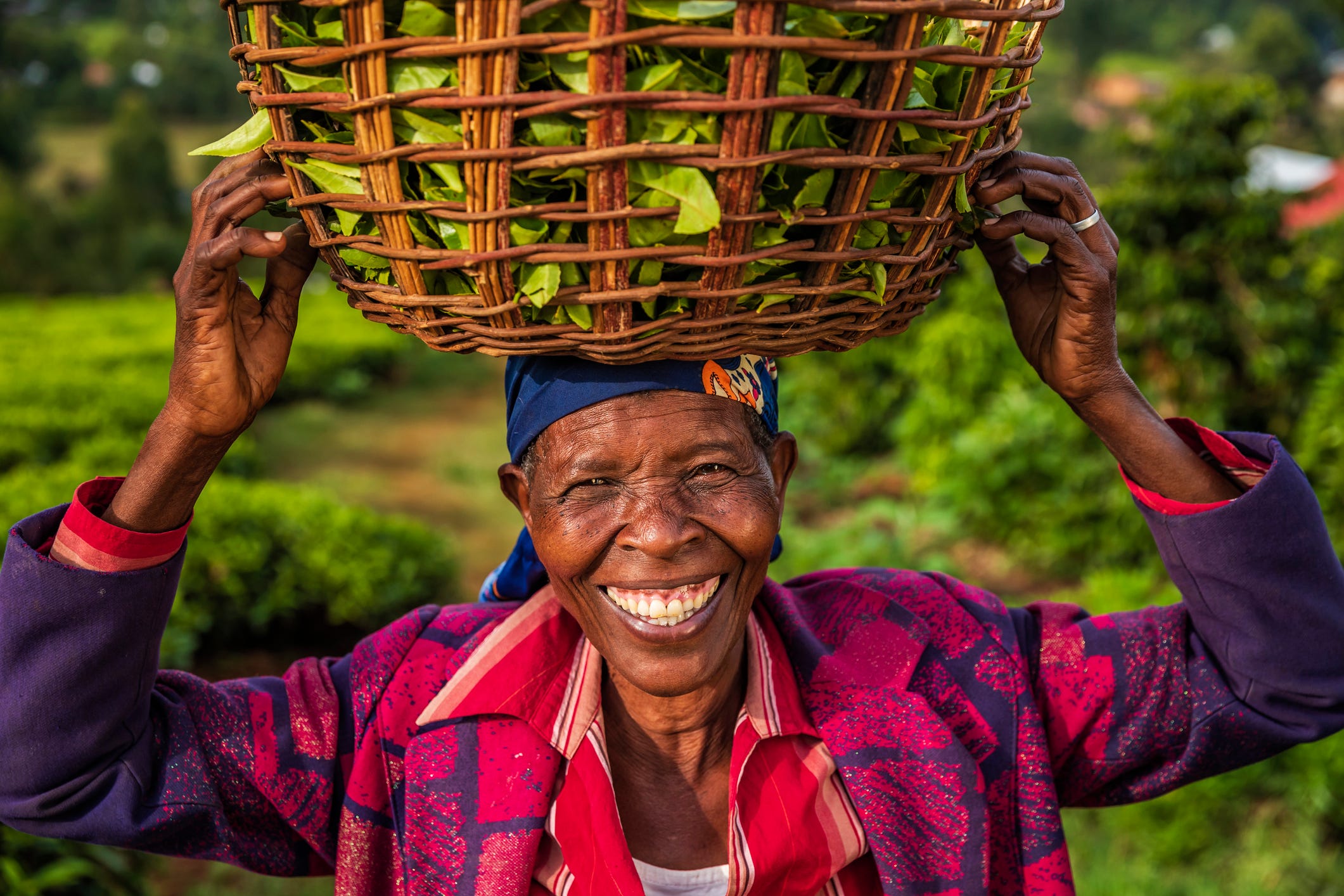 Woman smiling holding basket of crops