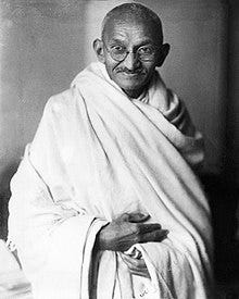 Mahatma Gandhi photo- bald Indian man in a wrap cloth with penny-rim glasses