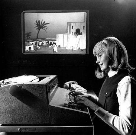 A balck-and-white photo of Mabel Addis at work. She is a young woman with straight hair dressed in ‘60’s style.