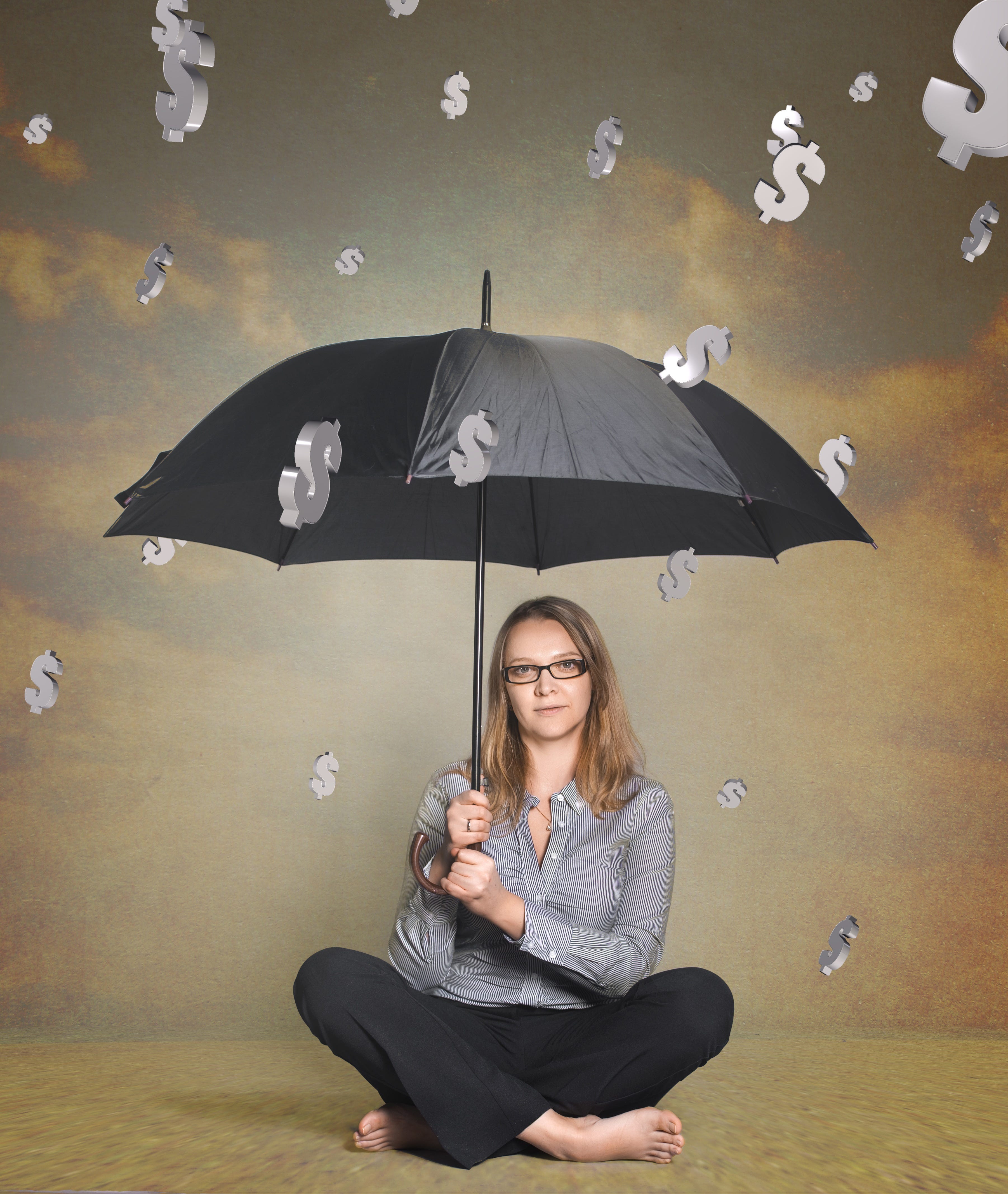 Woman sitting underneath umbrella with the money symbol fall down onto her.