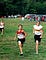 Luke Brenneman pictured running beside another competitor who is within his age range but clearly larger in stature.