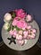 A bouquet of pink roses on a small round table.