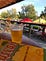 A photo of a beer and book (“How to Leave Hialeah”) on a table at Depot Park in Gainesville, Fla.
