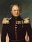 Alexander I in a black military uniform with golden epaulets, golden buttons, and numerous awards pinned to his chest.