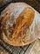 Close up of a round loaf of sourdough bread.